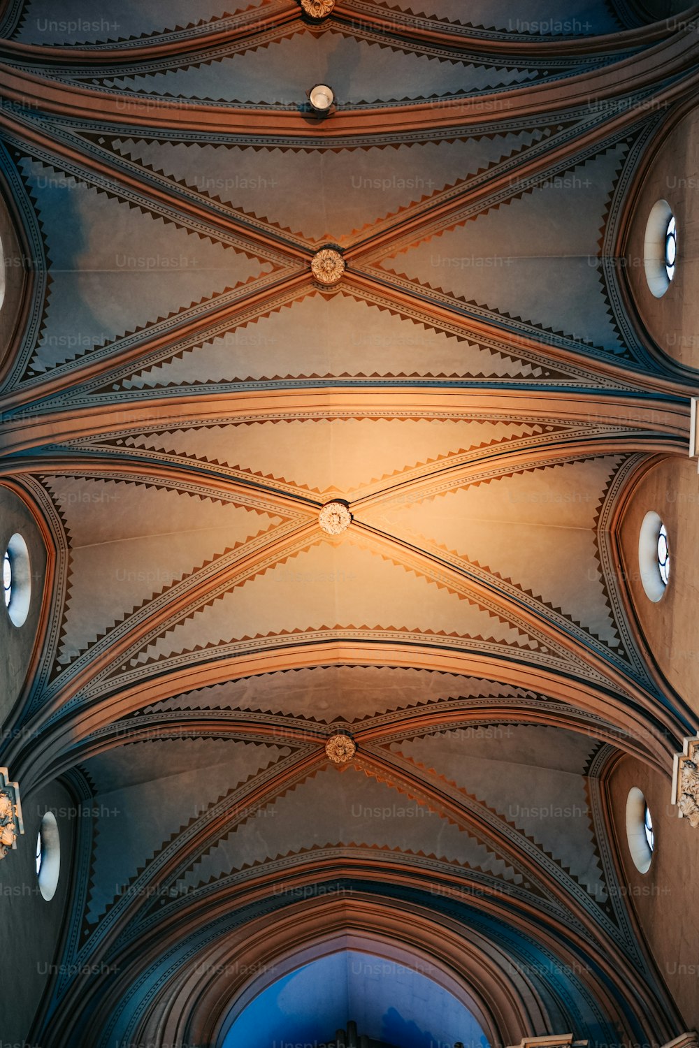 the ceiling of a large cathedral with many windows