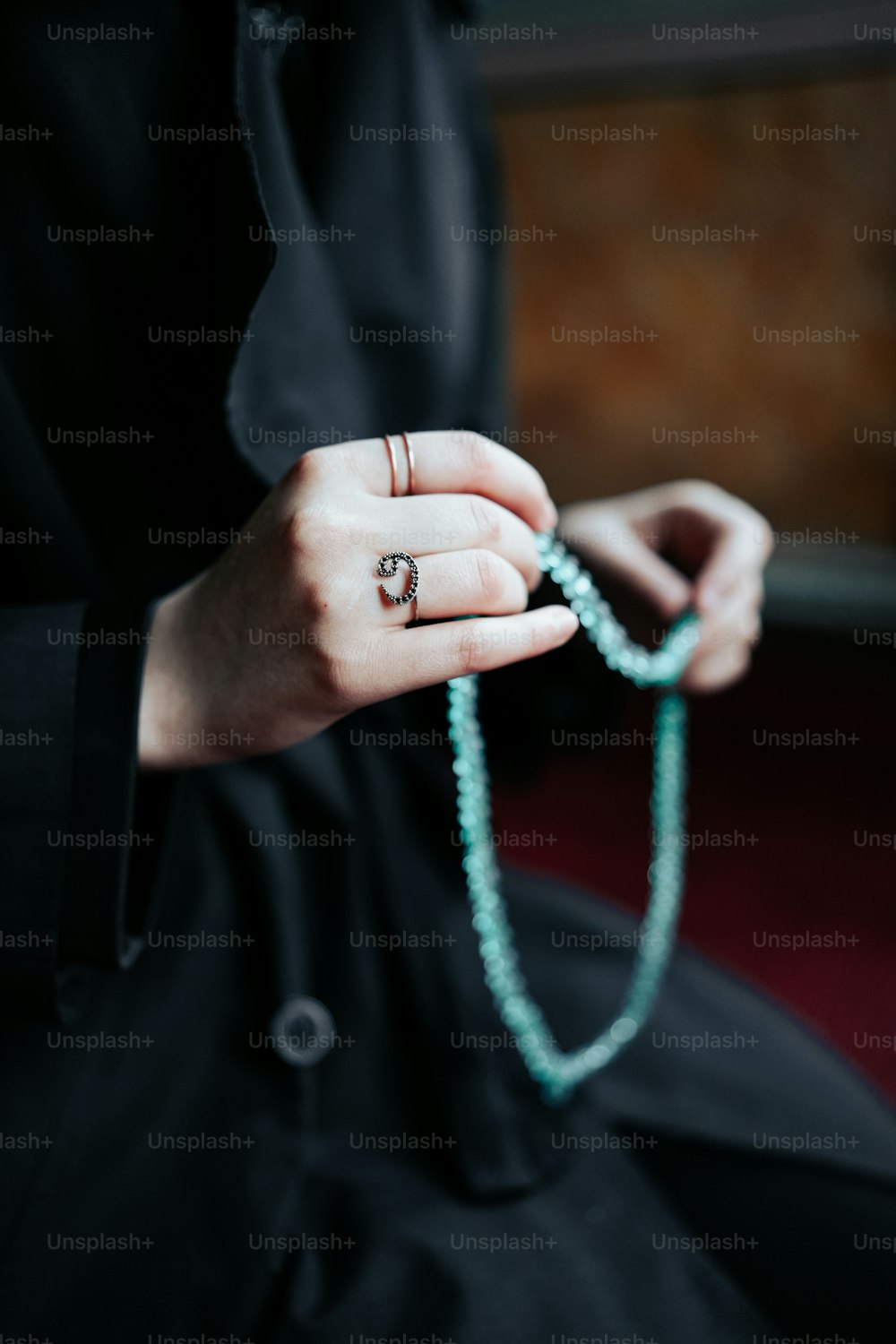 a woman is holding a rosary in her hands