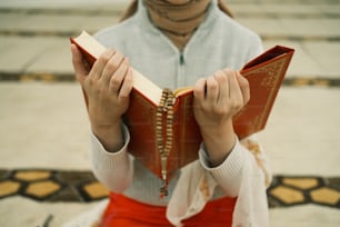 a woman is holding a book in her hands