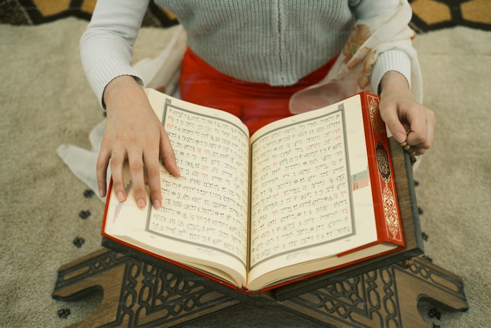 a woman is holding a book in her hands