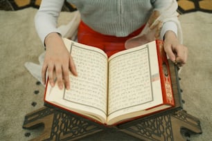 a woman is holding a book in her hands