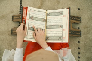 a person is reading a book on the floor