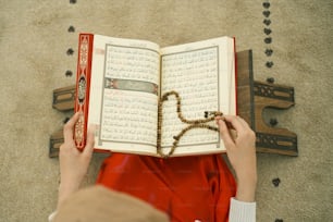 a person reading a book with a rosary