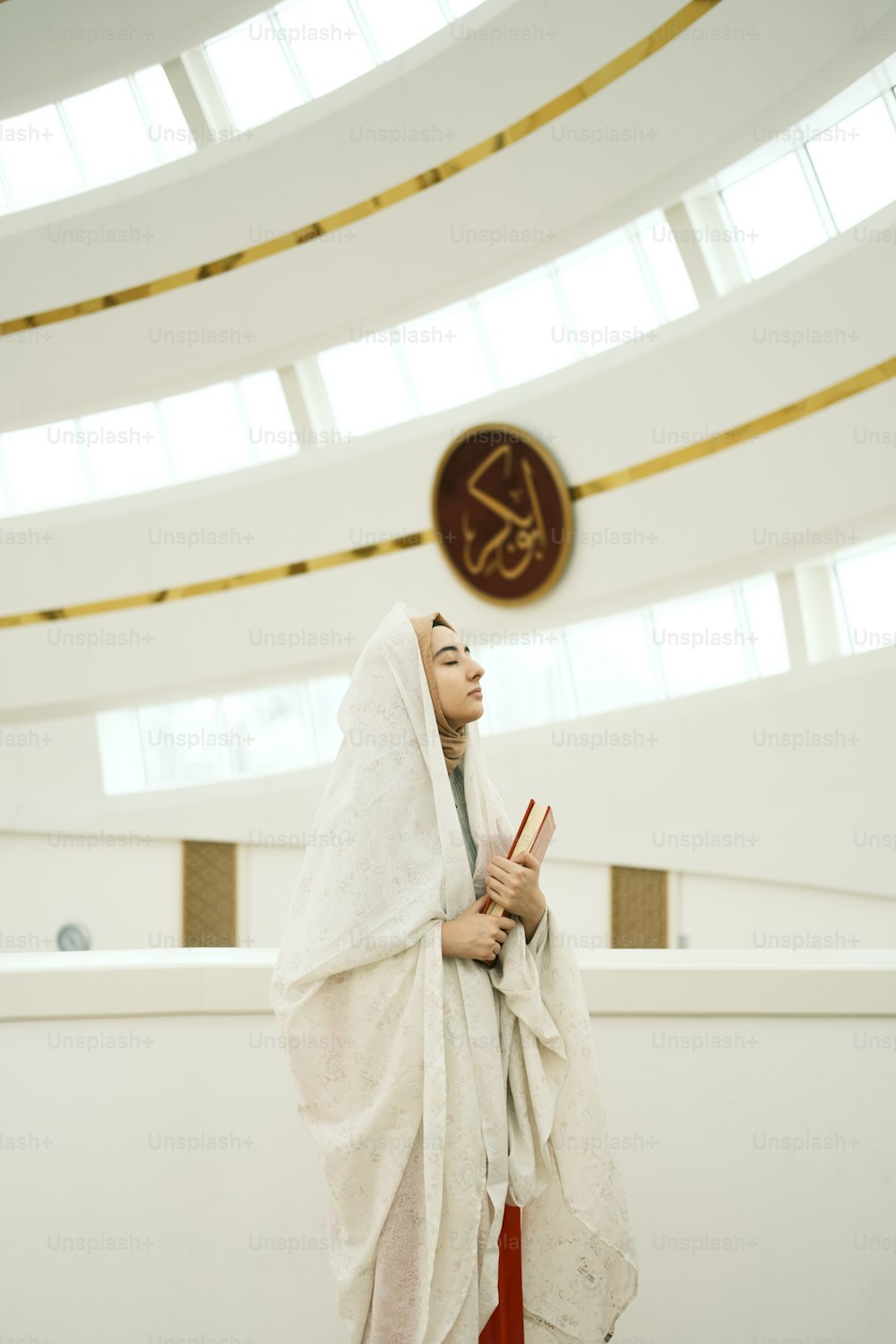 a woman in a white robe standing in a room