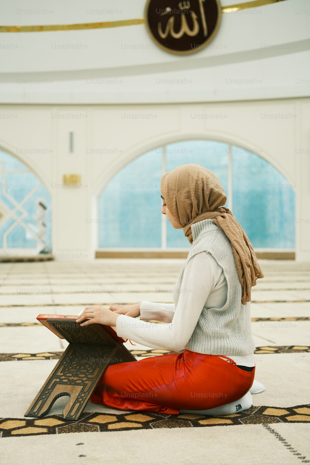a woman sitting on the floor using a laptop