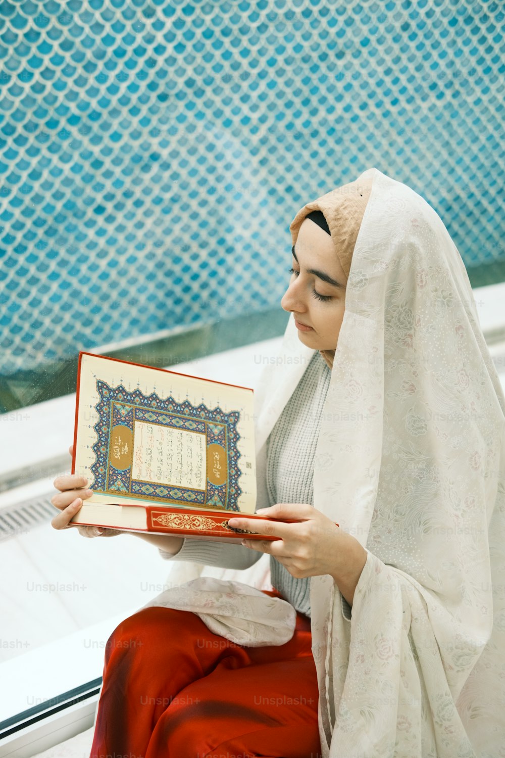 a woman in a veil holding a book