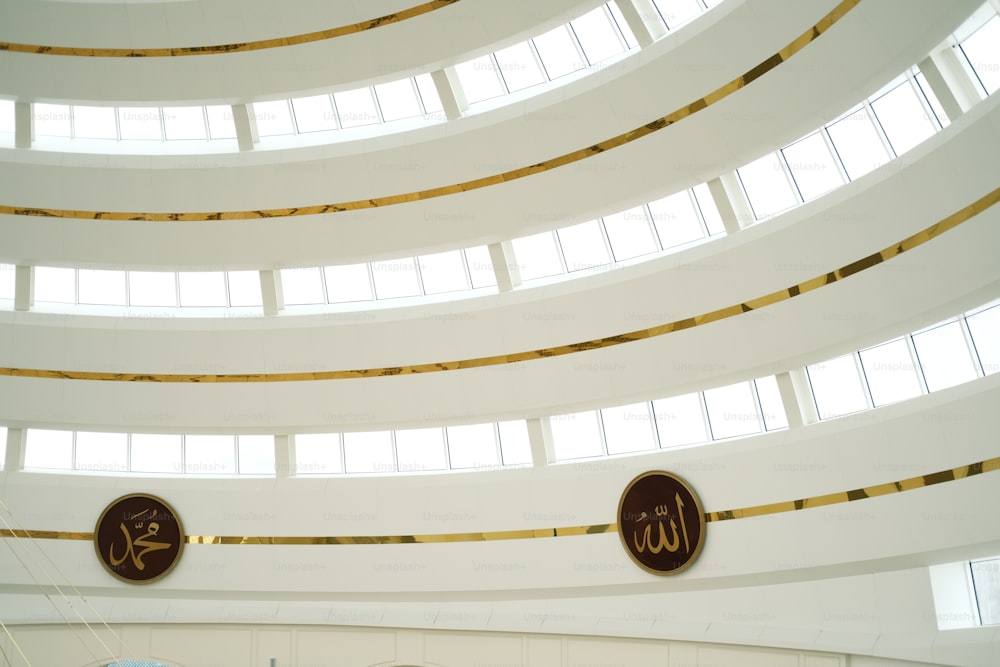 the ceiling of a large building with two circular signs above it