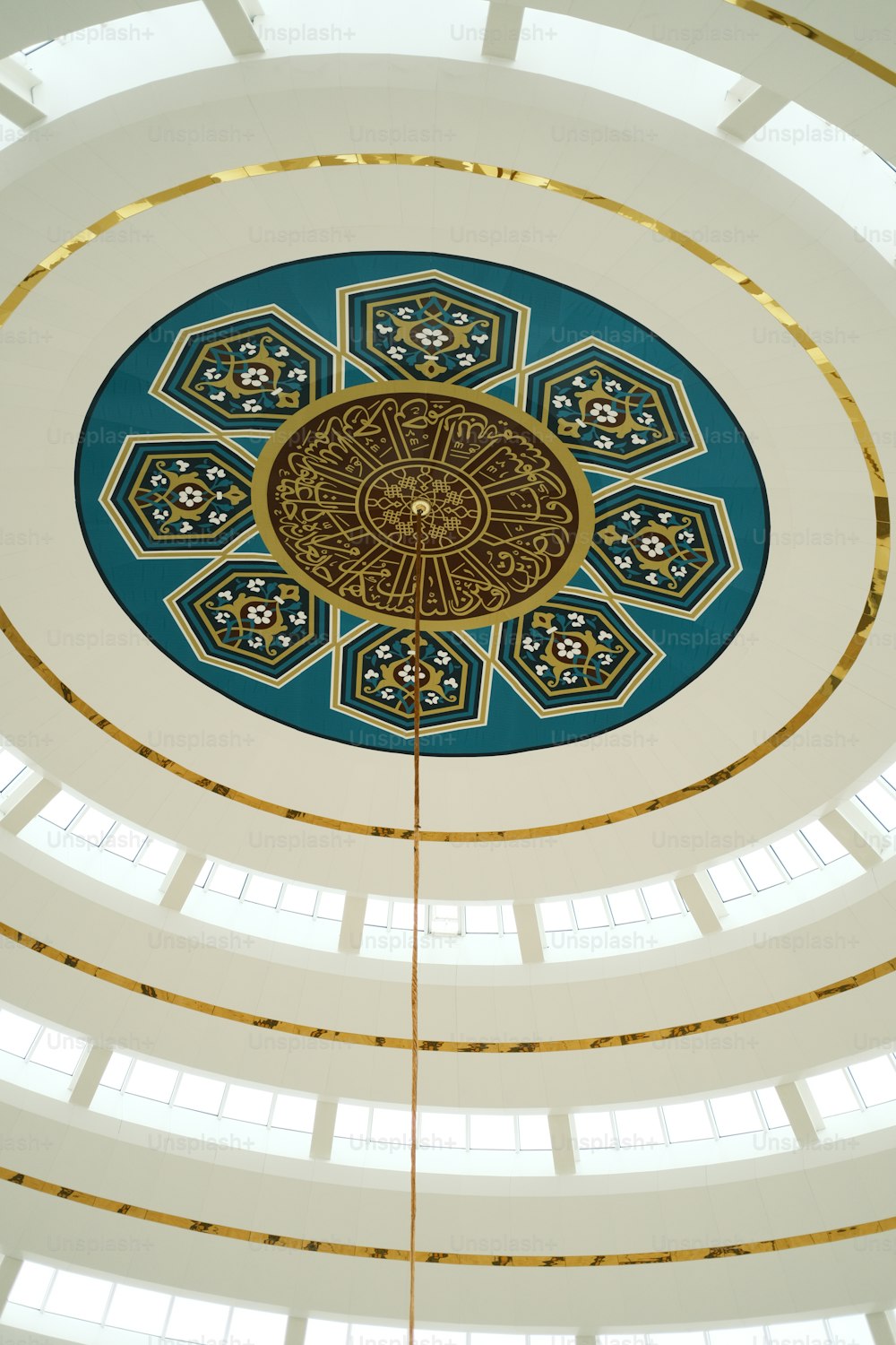 the ceiling of a large building with a clock on it