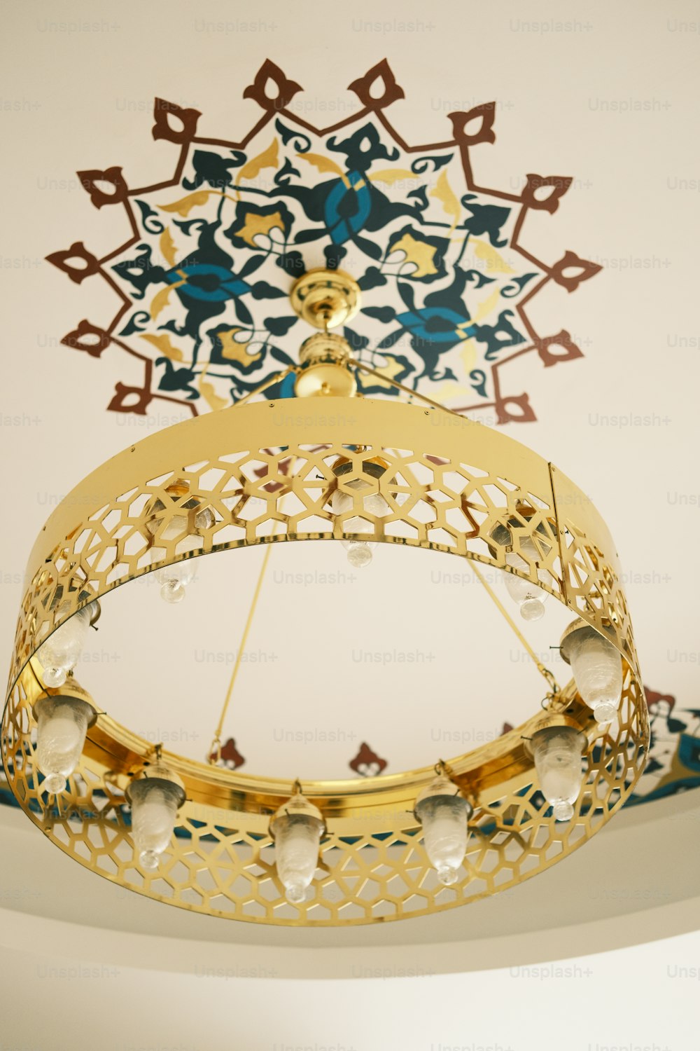 a gold and blue chandelier hanging from a ceiling