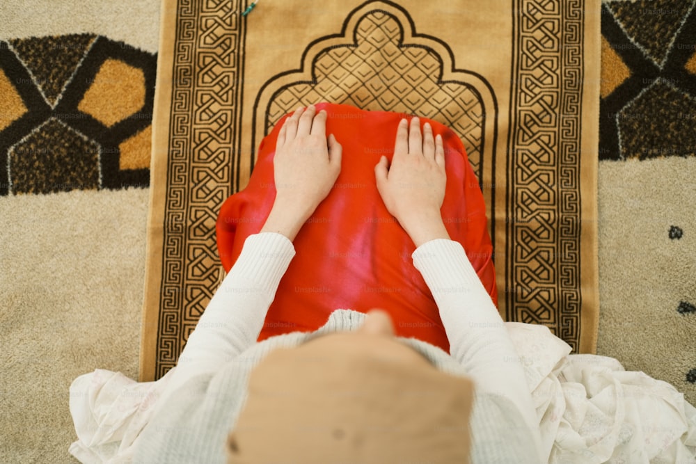 a person laying on a rug with their feet on a chair