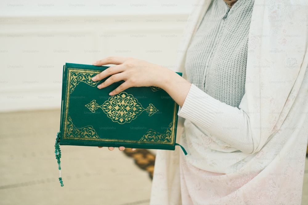 a woman is holding a book in her hands