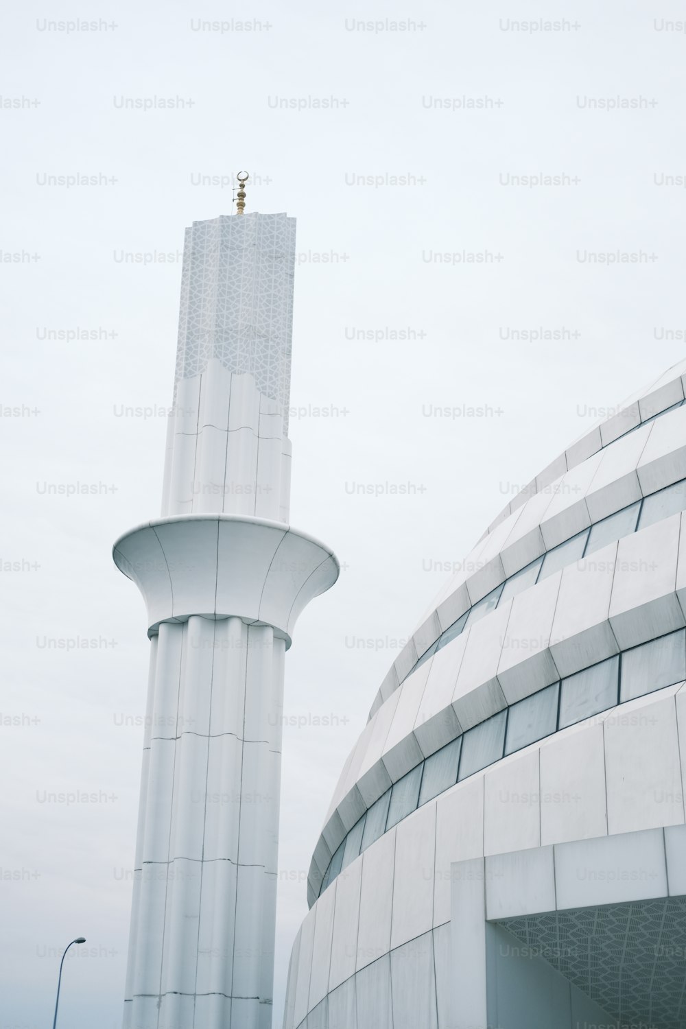 a large white building with a tall tower in the background