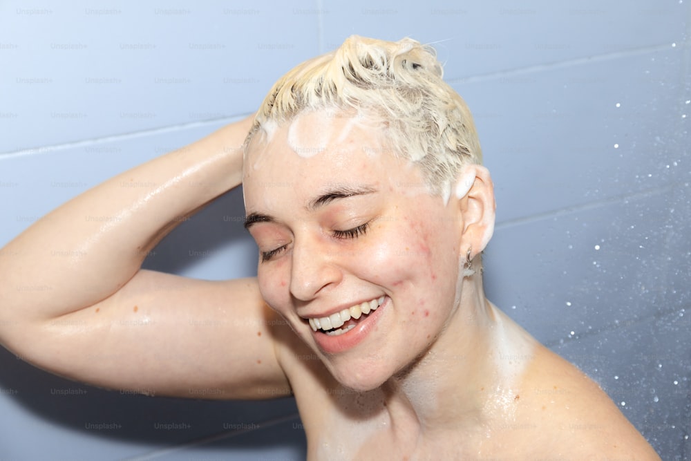 a woman is smiling while she takes a shower