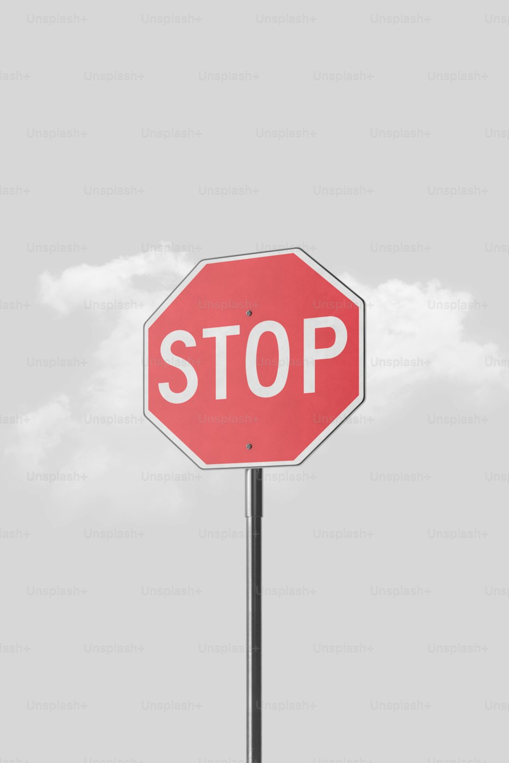 Un segnale di stop rosso seduto in cima a un palo di metallo