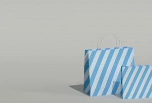 a pair of blue and white striped shopping bags
