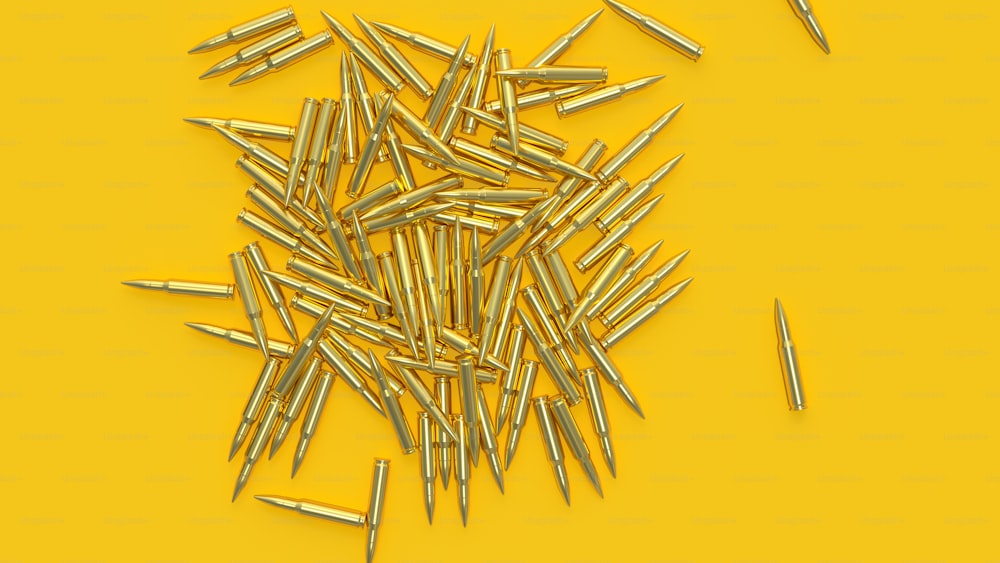 a bunch of nails laying on top of a yellow surface