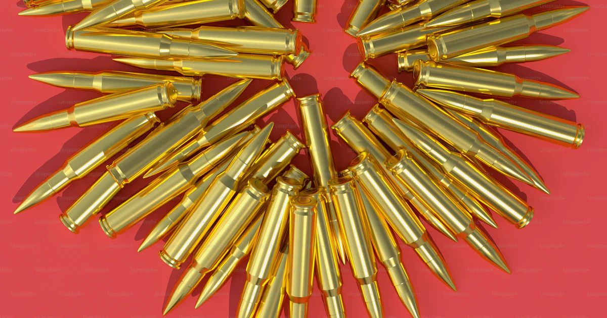 A bunch of bullet shells on a pink background photo – Bullet Image on ...