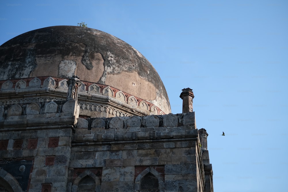 an old building with a dome and a bird sitting on top of it