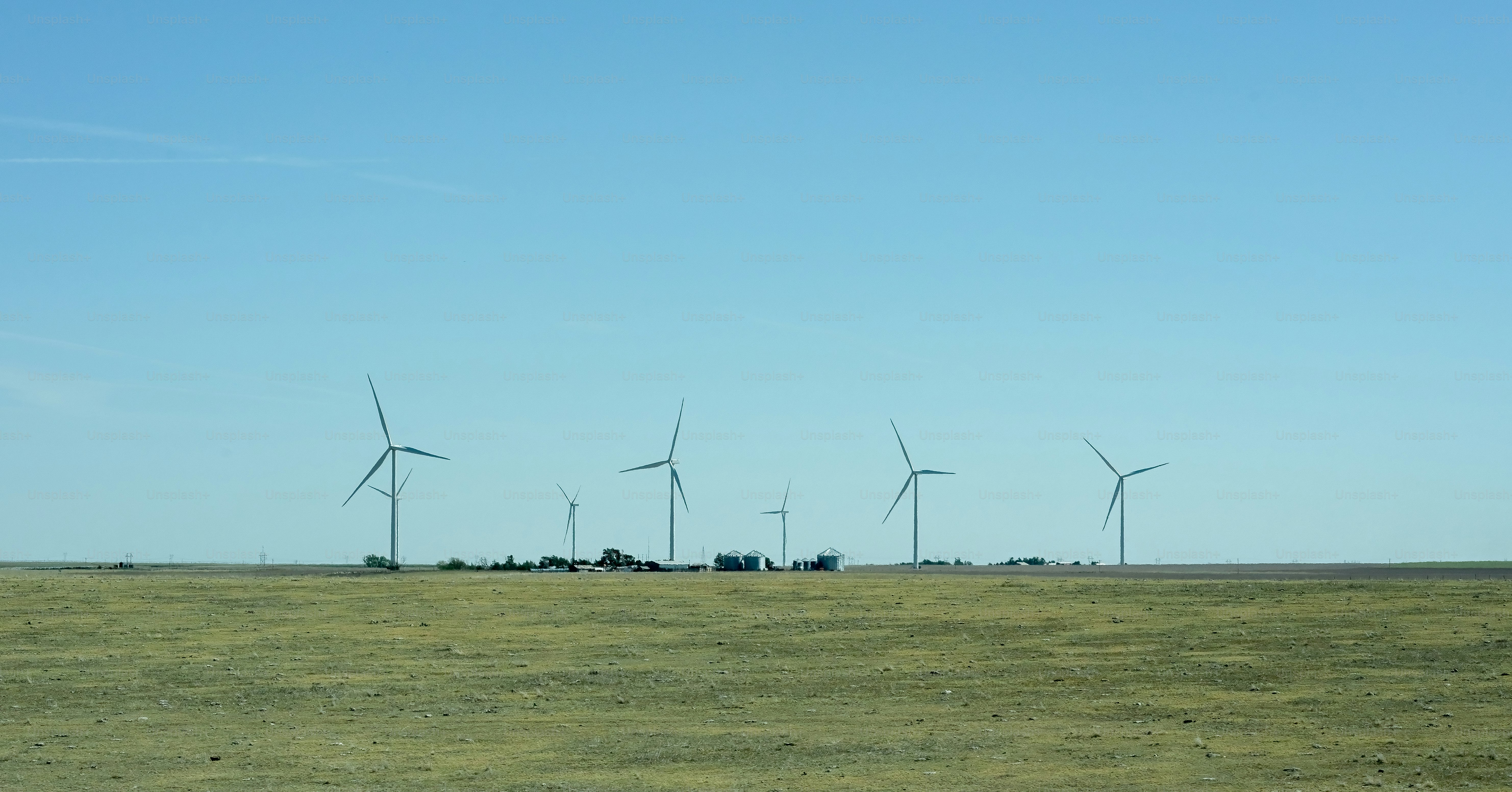 a group of wind turbines in a field
