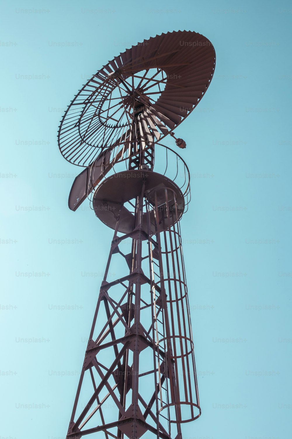 a metal tower with a fan on top of it