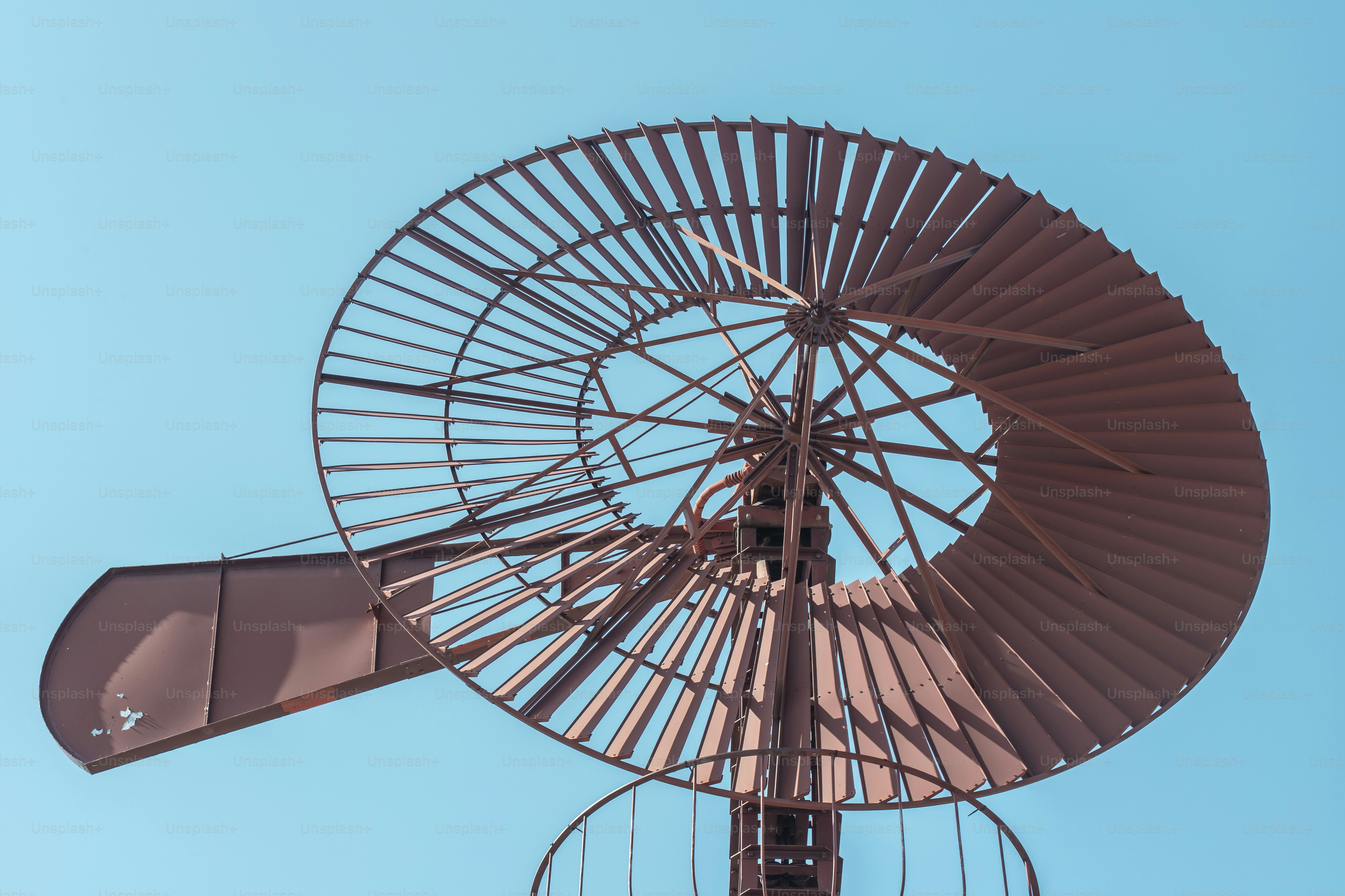 a large metal object with a blue sky in the background