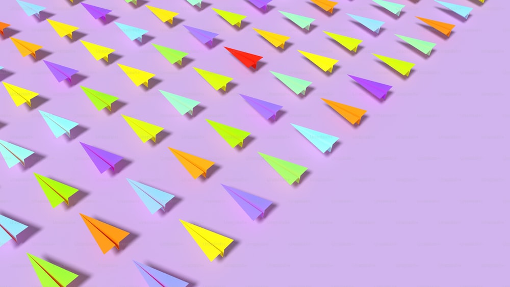 Eine Gruppe bunter Papierflugzeuge auf violettem Hintergrund
