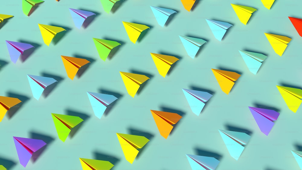 Un gruppo di aeroplanini di carta colorati su uno sfondo blu