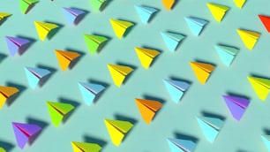 青の背景にカラフルな紙飛行機のグループ