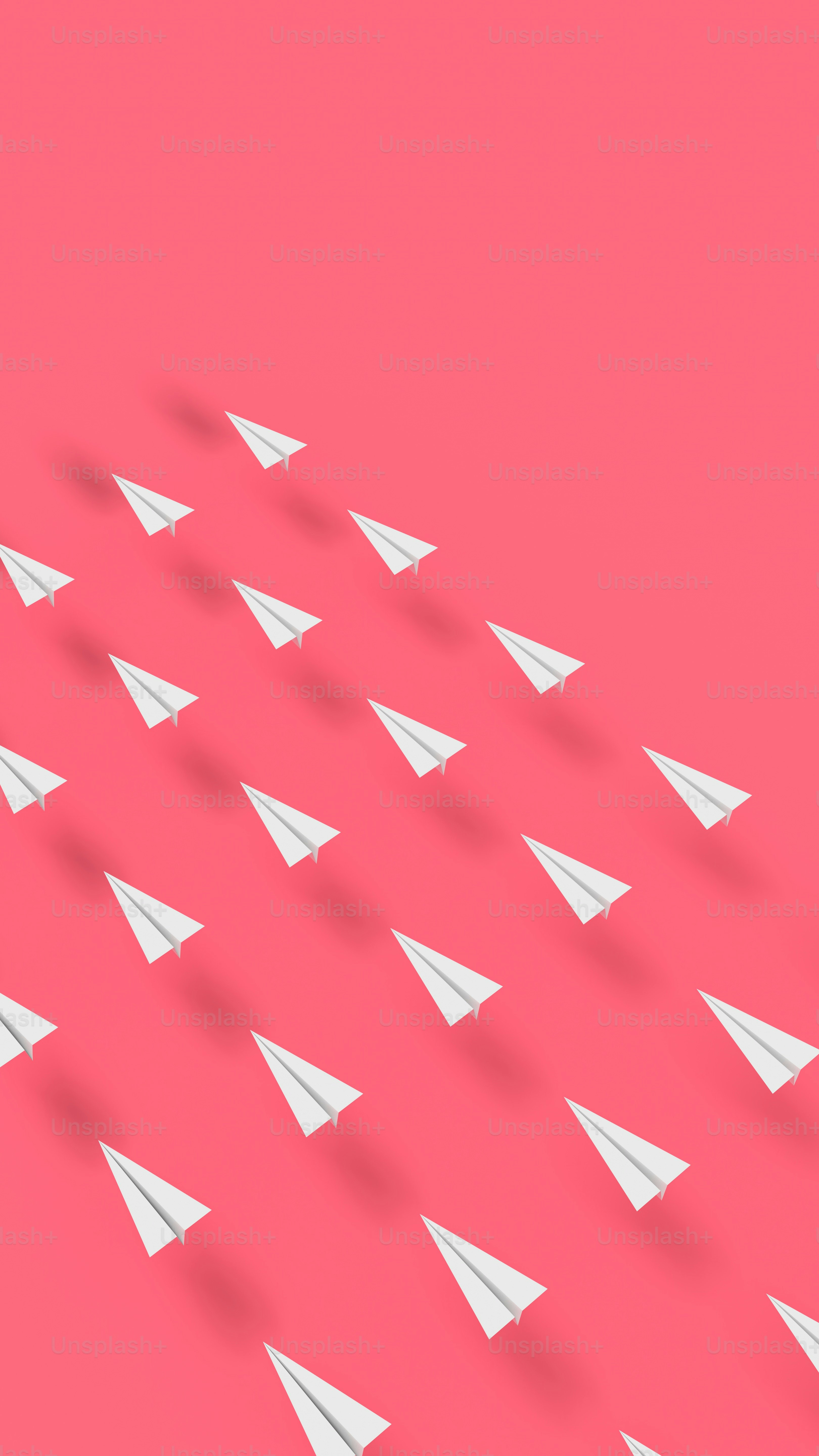 a group of paper airplanes flying in the air