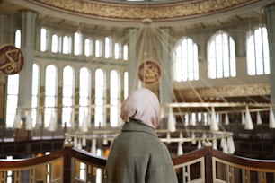 a woman in a hijab is looking at the ceiling