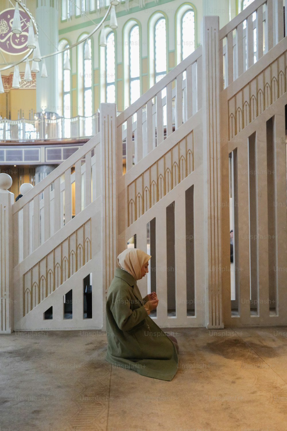 a person sitting on the ground in front of some stairs