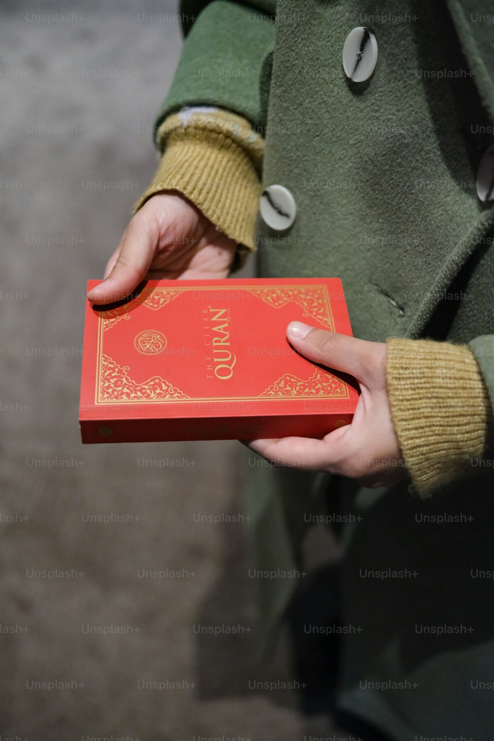 a person holding a red box in their hands