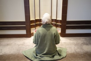 a person sitting on the floor in a room