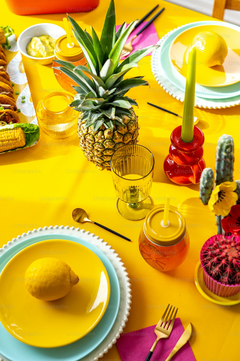 a pineapple sits on a yellow table cloth