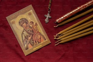 a picture of a woman holding a child on a red cloth