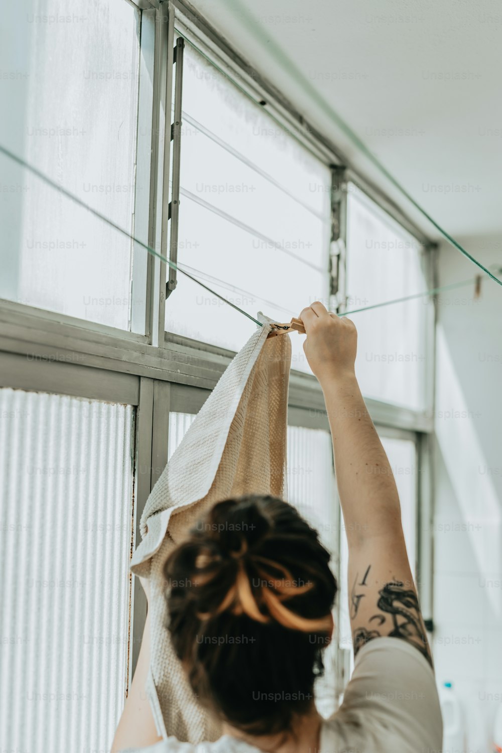 a woman hanging a bag on a clothes line