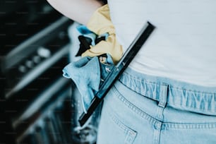 a person wearing a pair of jeans and a yellow glove