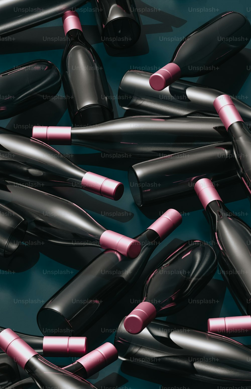 a group of black and pink lipsticks on a blue surface