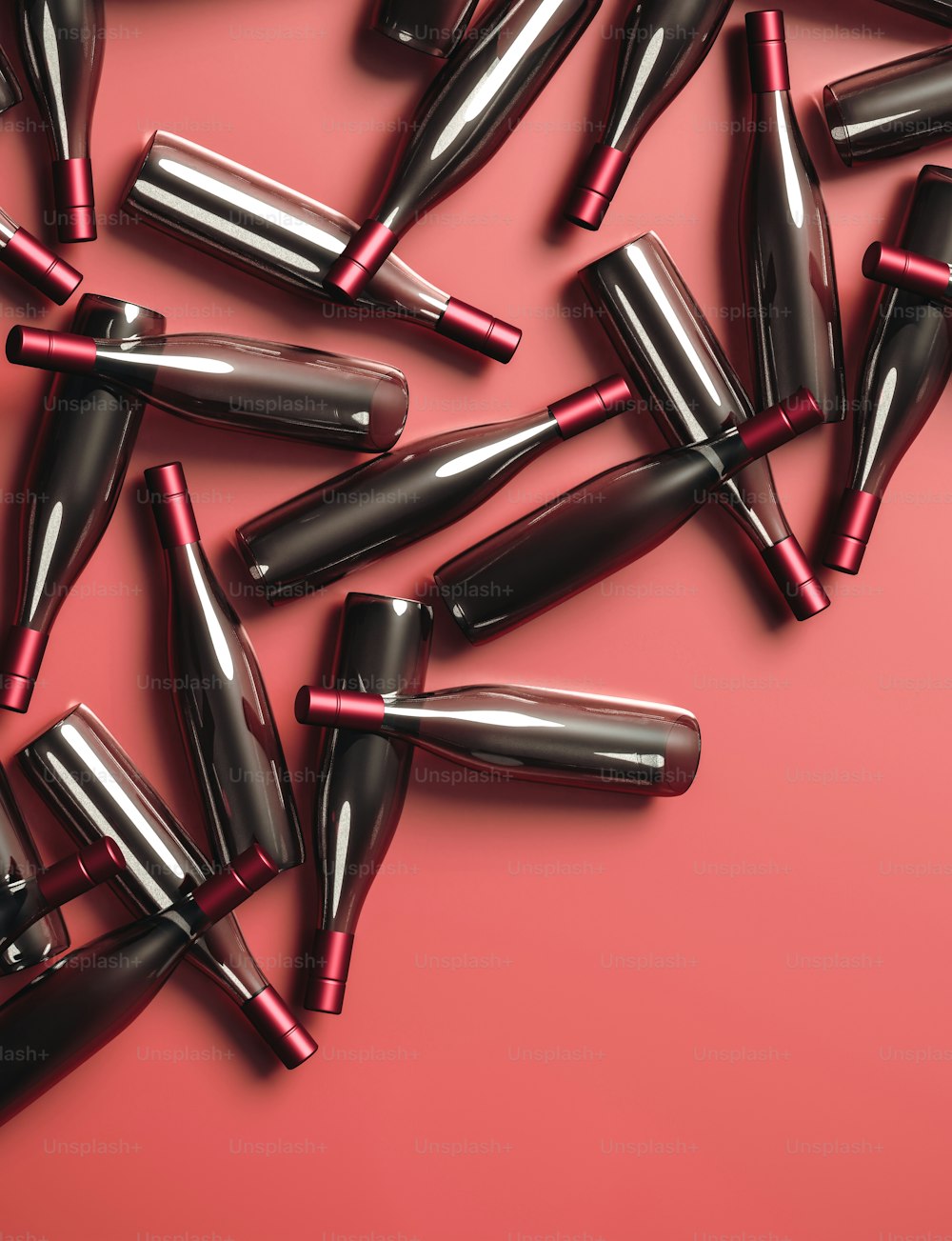 Un grupo de lápices labiales negros y rojos sobre un fondo rosa