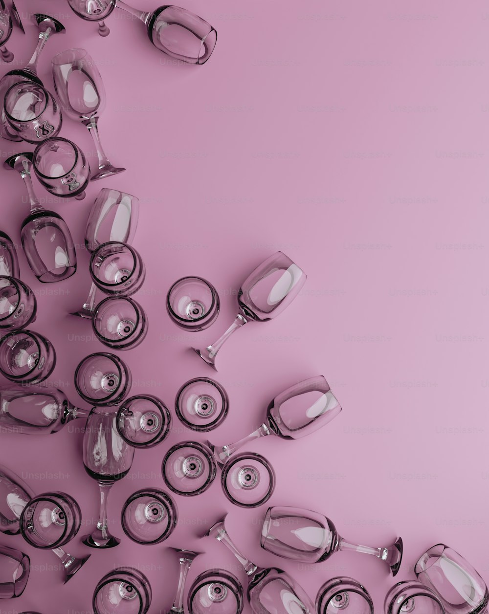 a group of wine glasses on a pink background