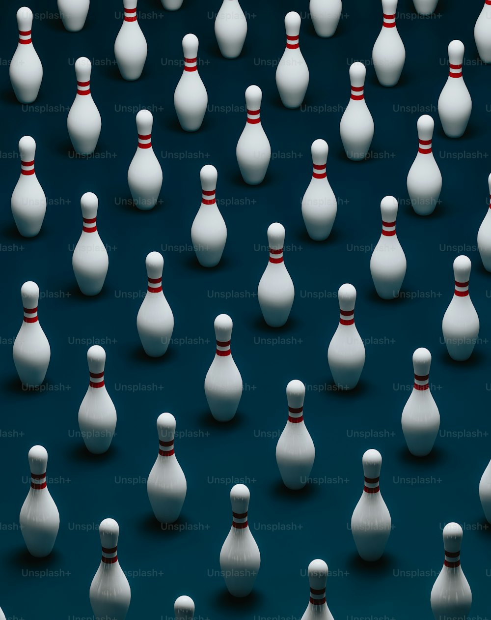 a group of white bowling pins sitting on top of a blue surface
