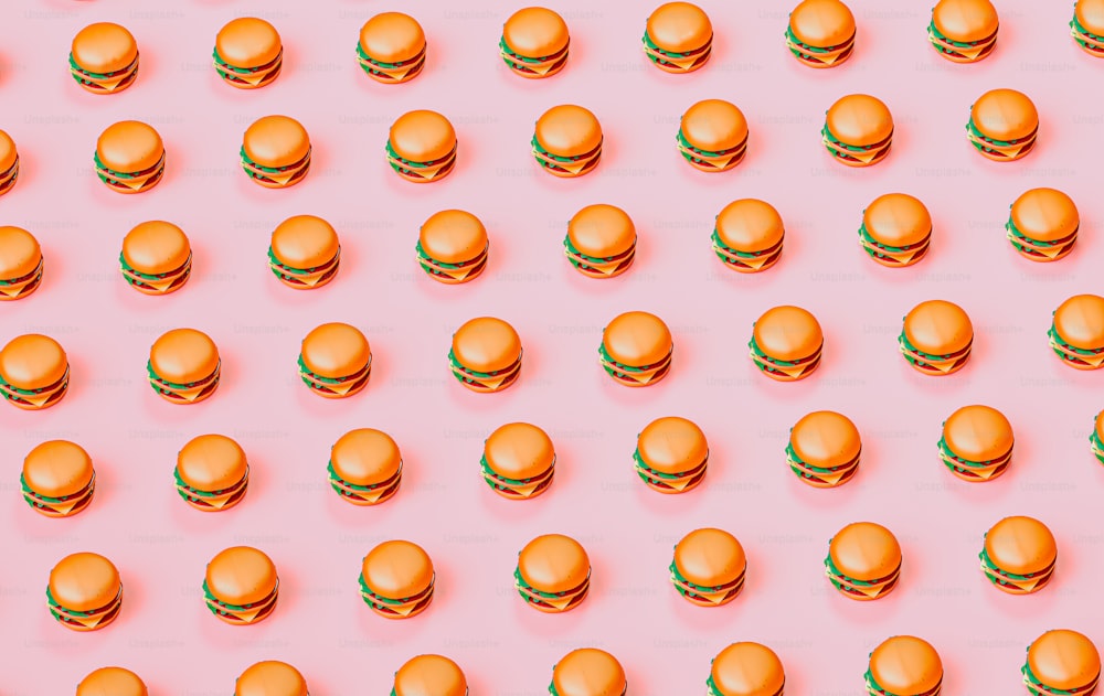 a lot of hamburgers that are on a pink surface