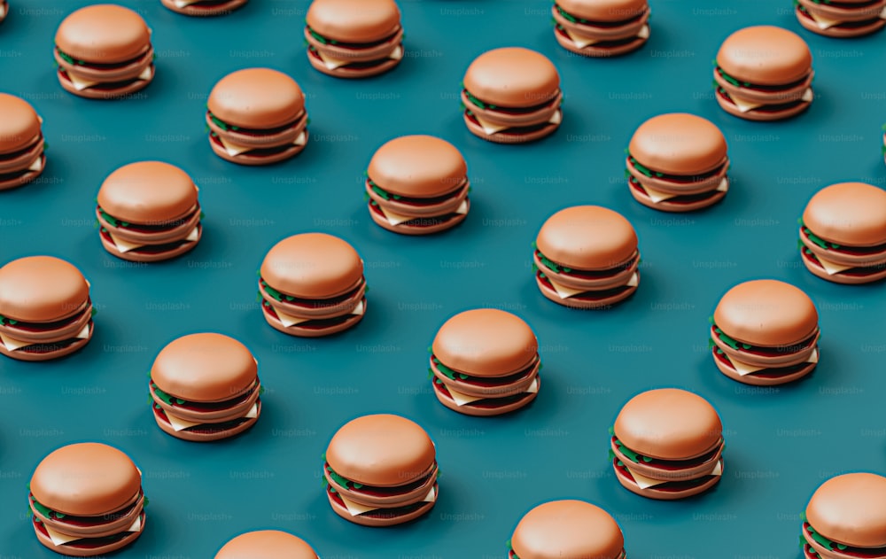 a group of hamburgers sitting on top of a blue surface