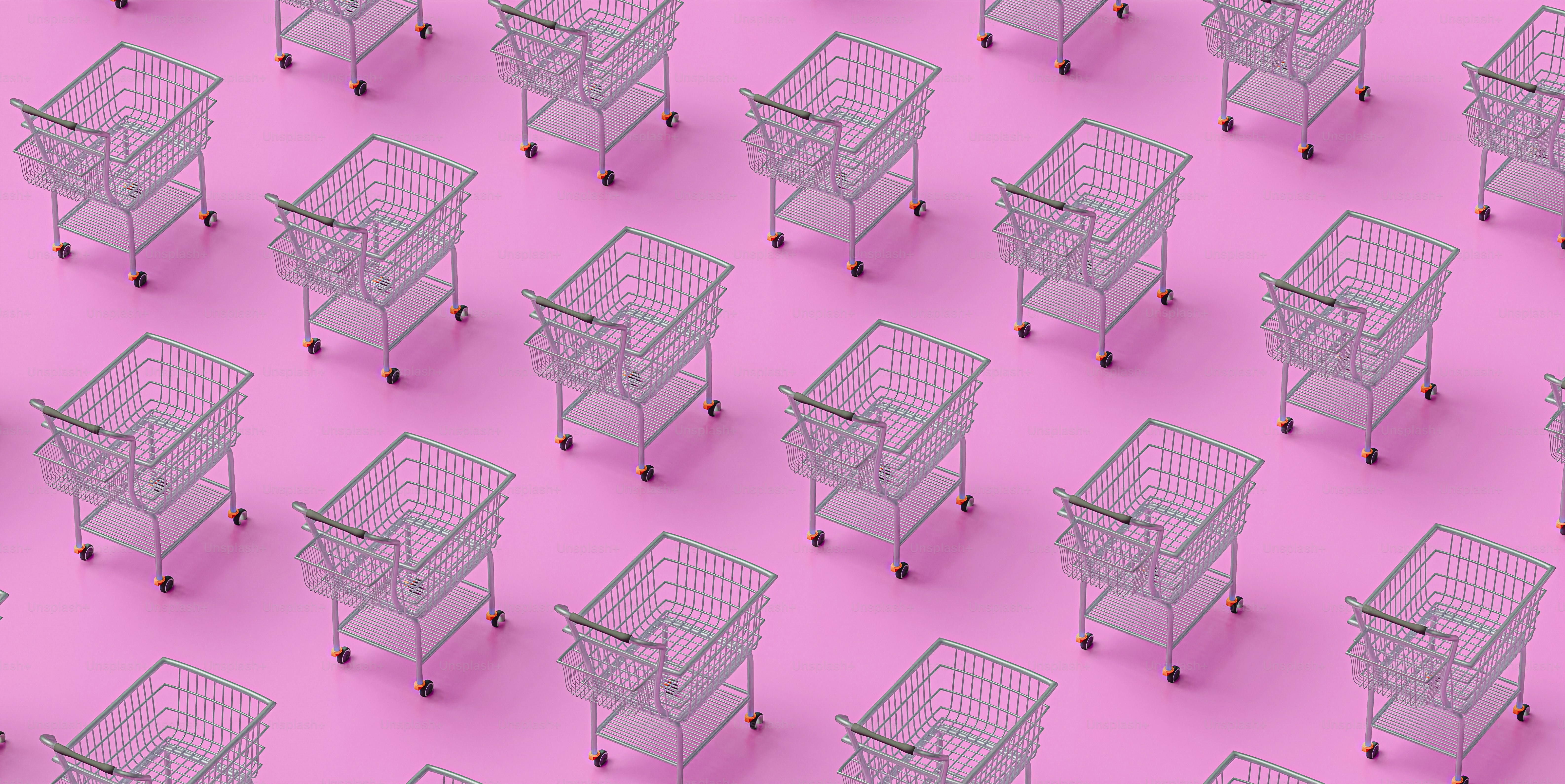 A group of shopping carts sitting on top of a pink floor photo ...