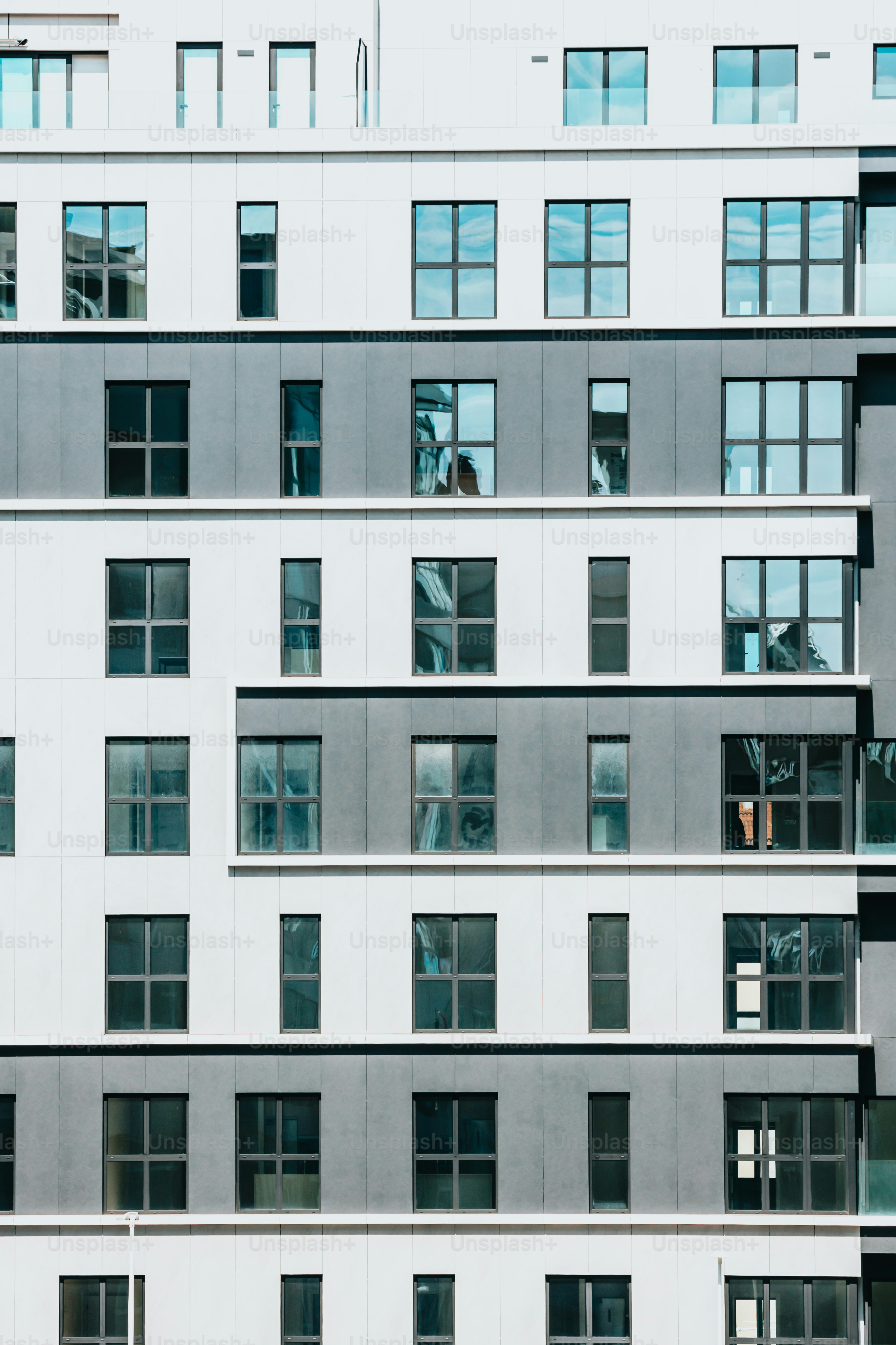 a tall building with lots of windows next to a parking meter