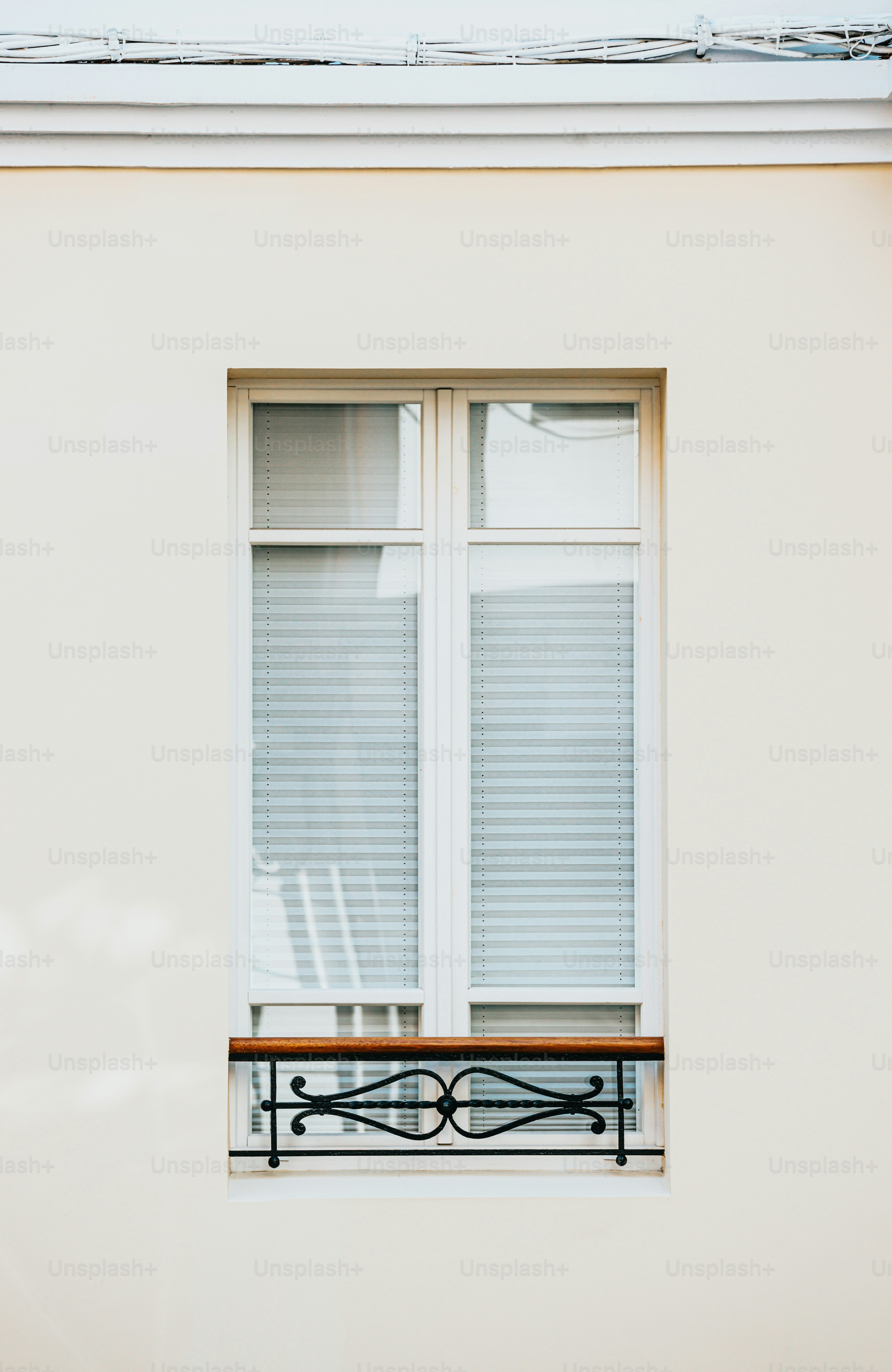 A white building with a wooden bench in front of it photo ...