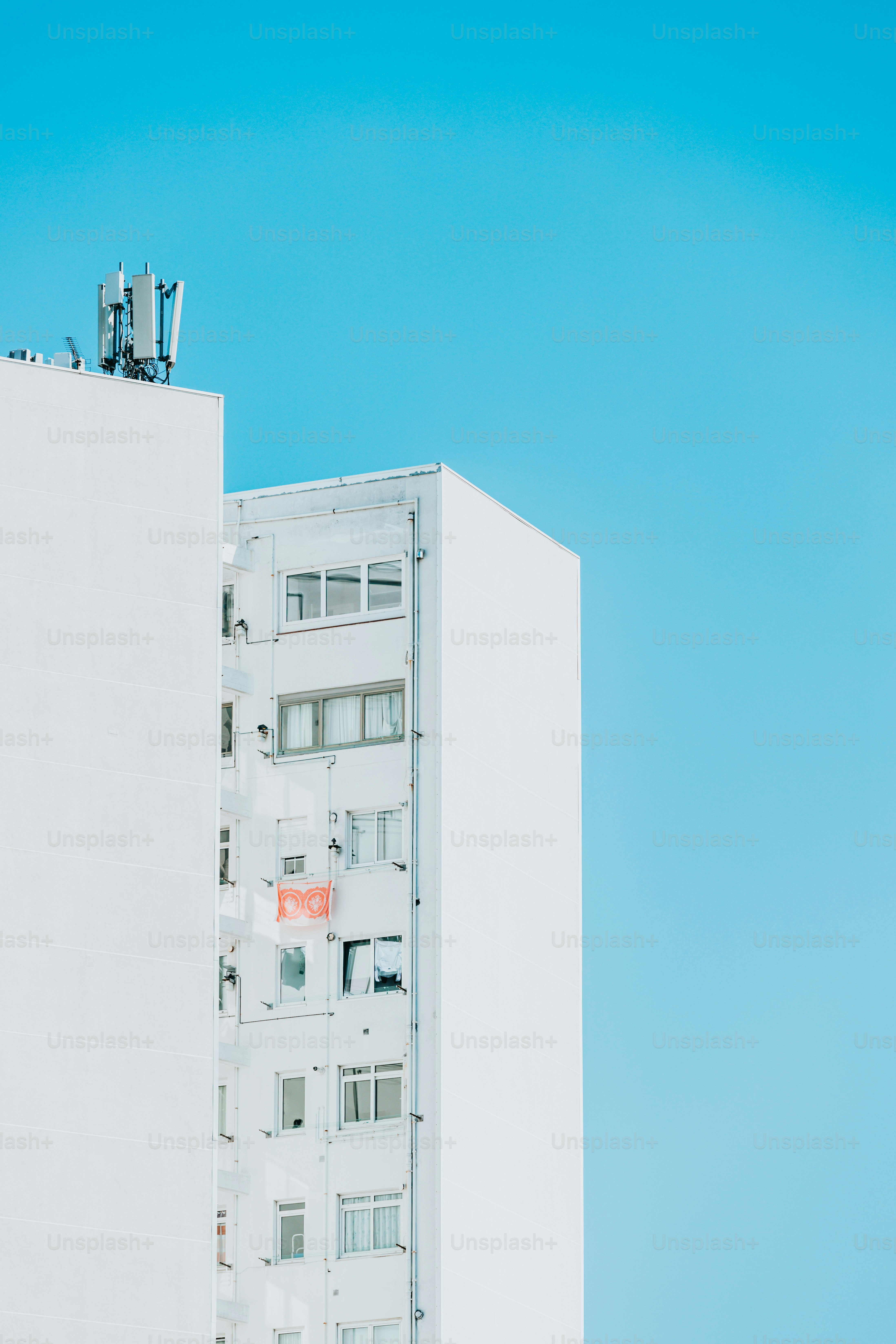 a tall white building with a sky background