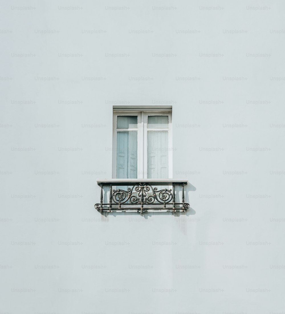 a white building with a balcony and a window