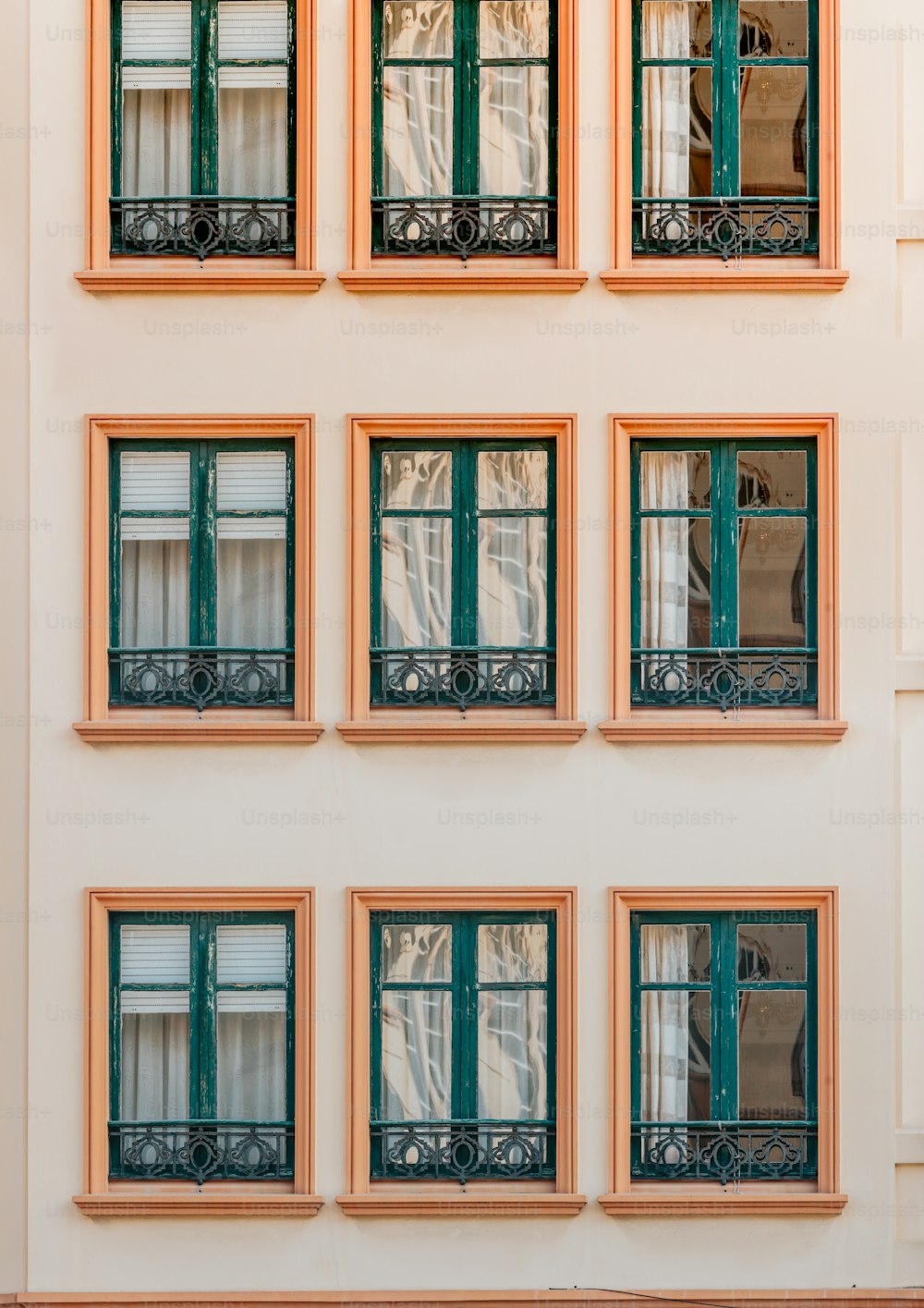 a building with many windows and green shutters