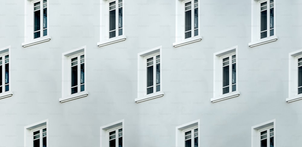 a white building with many windows and a clock